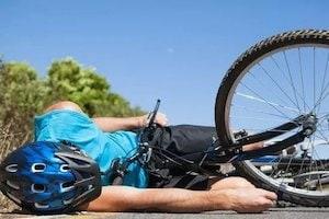 Cyclist Lying On The Road After An Accident